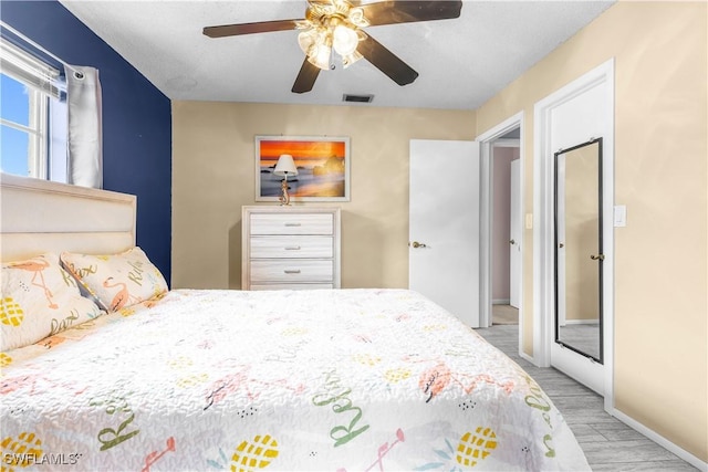 bedroom featuring light hardwood / wood-style floors and ceiling fan