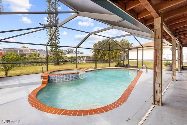 view of pool featuring an in ground hot tub, a yard, glass enclosure, and a patio area