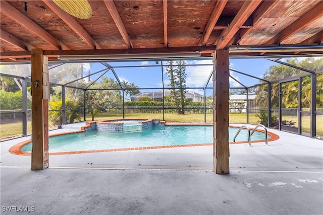 view of pool featuring a lanai, a patio area, and an in ground hot tub