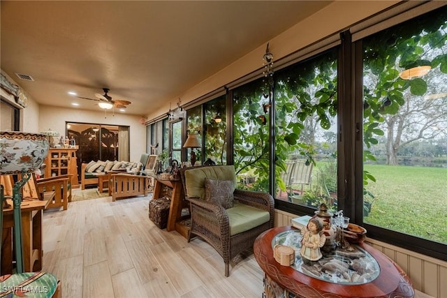 sunroom featuring ceiling fan