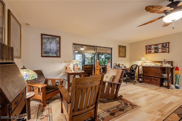 dining space with ceiling fan and light wood-type flooring