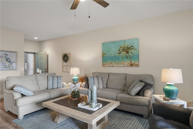 living room with hardwood / wood-style flooring and ceiling fan