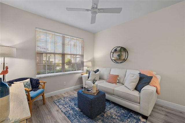 living room featuring light hardwood / wood-style flooring and ceiling fan