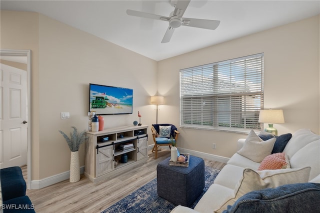 living room with light hardwood / wood-style flooring and ceiling fan