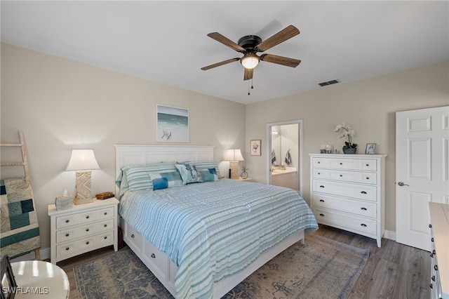 bedroom with ceiling fan, connected bathroom, and dark hardwood / wood-style flooring