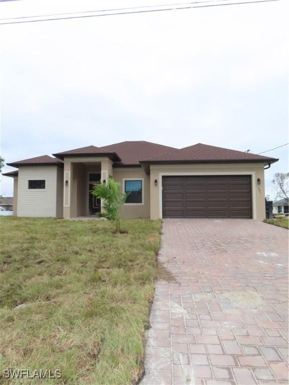 view of front facade with a garage and a front lawn