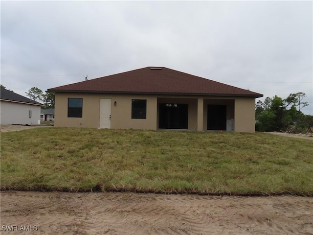 rear view of house with a lawn