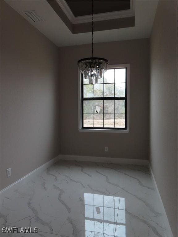 unfurnished dining area with a chandelier, a raised ceiling, and crown molding