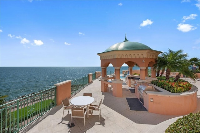 view of patio / terrace with a gazebo, a water view, and area for grilling