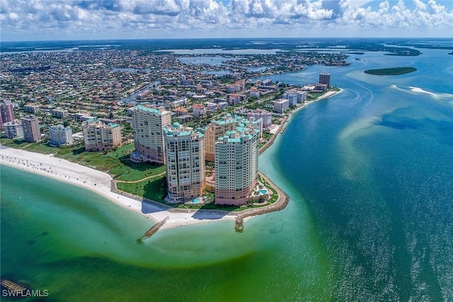 drone / aerial view with a beach view and a water view