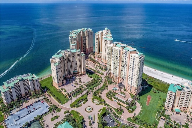 drone / aerial view featuring a beach view and a water view