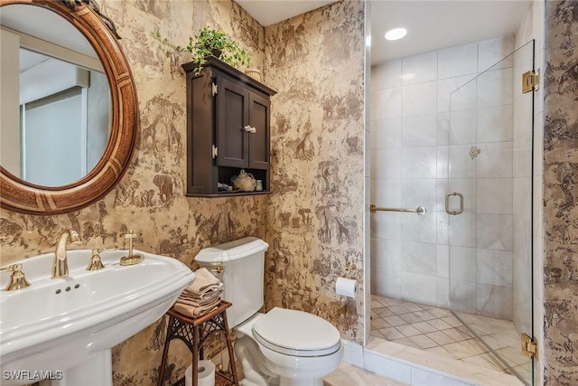 bathroom with sink, an enclosed shower, and toilet