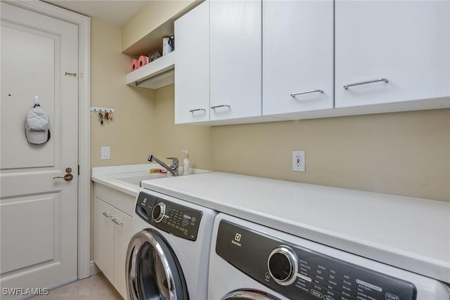 laundry room with cabinets, separate washer and dryer, and sink