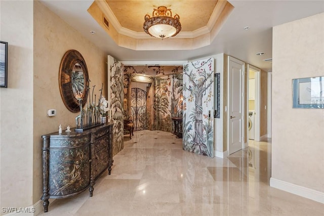 hall with crown molding and a tray ceiling