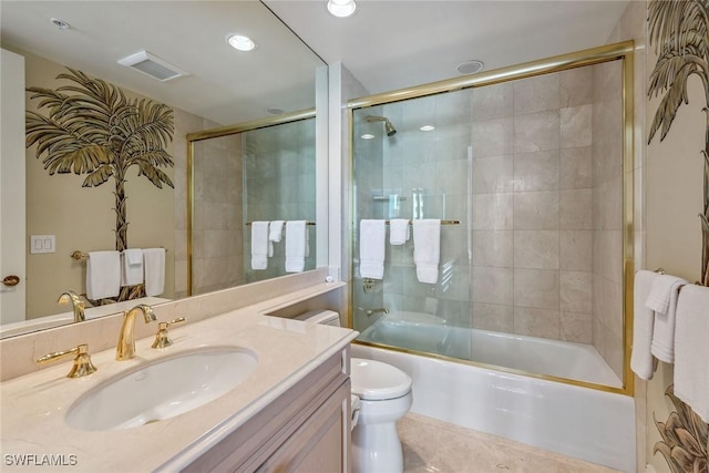 full bathroom featuring enclosed tub / shower combo, vanity, and toilet