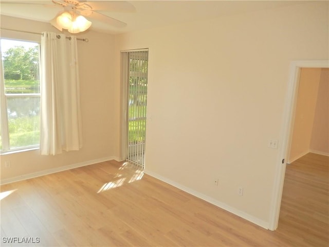 empty room with ceiling fan and light wood-type flooring