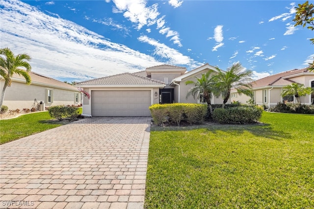 mediterranean / spanish home with a garage and a front yard