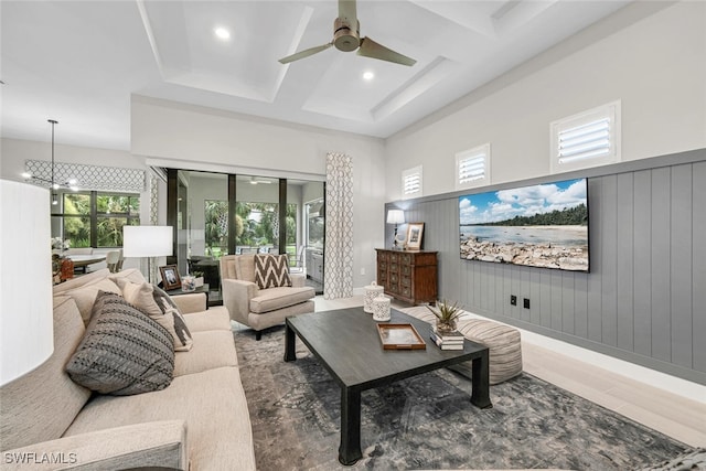 living room with plenty of natural light, coffered ceiling, beam ceiling, and wood-type flooring