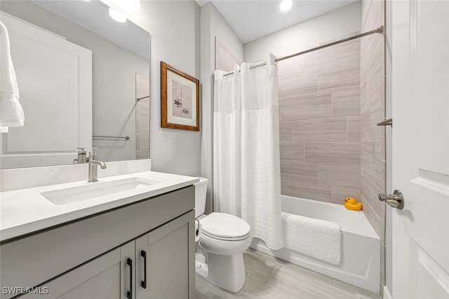 full bathroom featuring shower / tub combo with curtain, vanity, and toilet