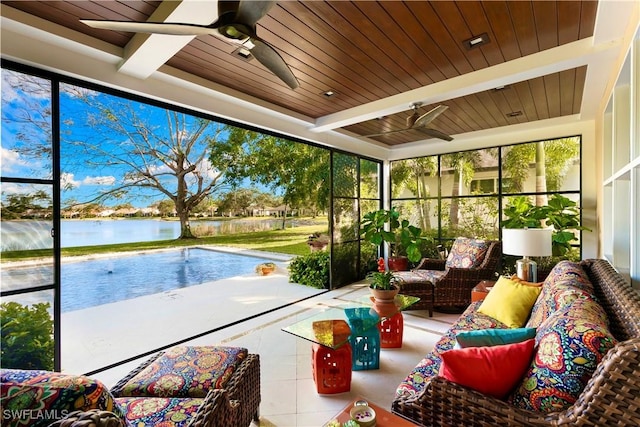 sunroom featuring ceiling fan, a water view, and wooden ceiling