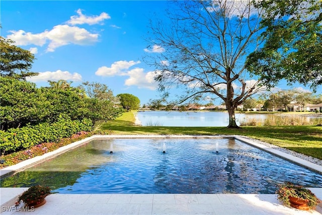 view of swimming pool with a water view and a lawn