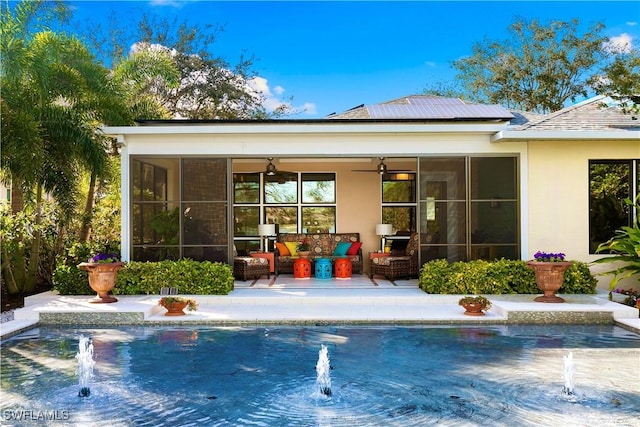 view of pool featuring an outdoor living space, pool water feature, a sunroom, and ceiling fan