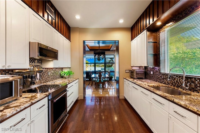 kitchen featuring dark hardwood / wood-style flooring, sink, light stone counters, appliances with stainless steel finishes, and white cabinets