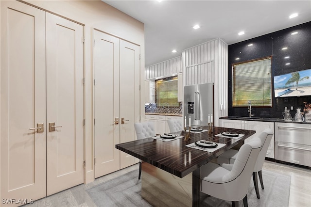 dining space featuring sink and white cabinets