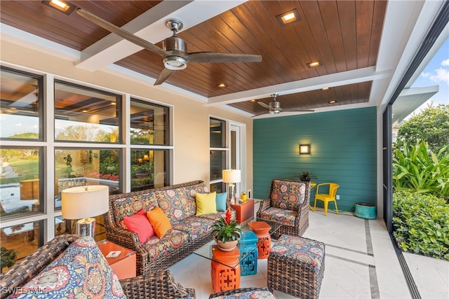 view of patio / terrace with beamed ceiling, ceiling fan, and wooden ceiling