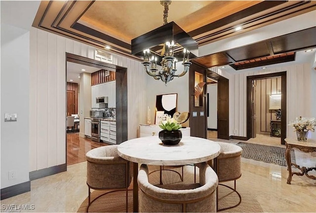 dining room with a tray ceiling and a notable chandelier