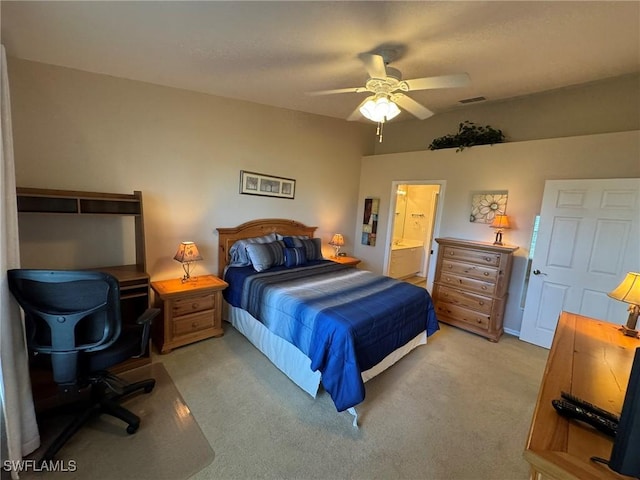 carpeted bedroom with ensuite bathroom and ceiling fan