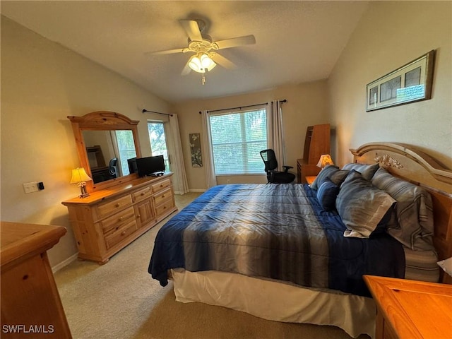 carpeted bedroom featuring vaulted ceiling and ceiling fan