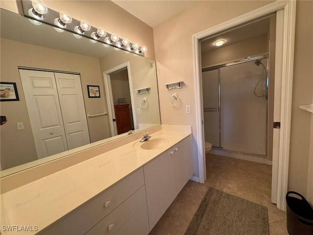 bathroom with toilet, tile patterned flooring, an enclosed shower, and vanity