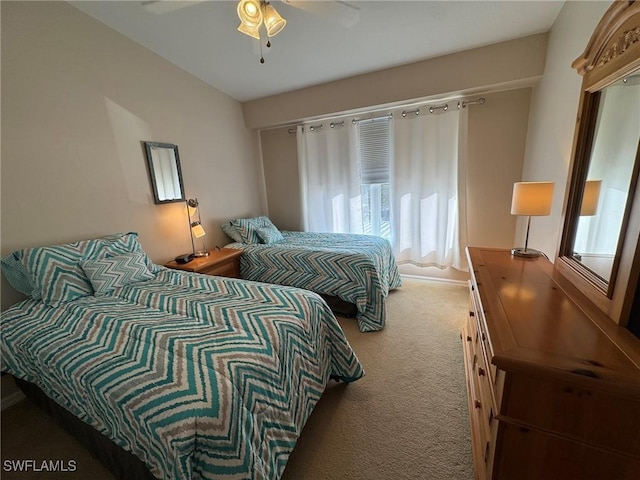 carpeted bedroom with multiple windows and ceiling fan