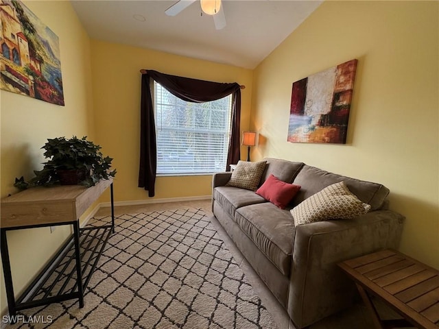 carpeted living room with ceiling fan and lofted ceiling