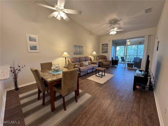 dining area featuring vaulted ceiling, ceiling fan, and dark hardwood / wood-style flooring