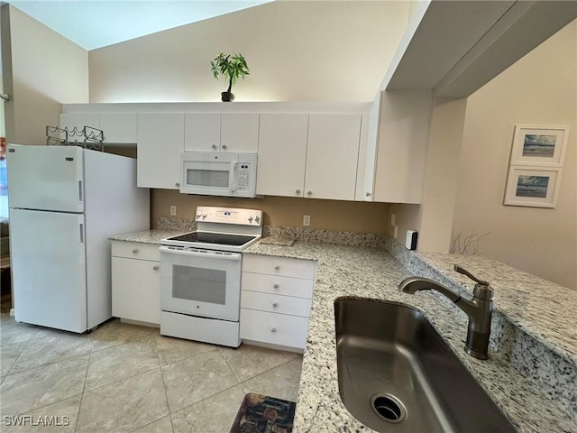 kitchen featuring light stone countertops, white appliances, white cabinetry, sink, and light tile patterned floors