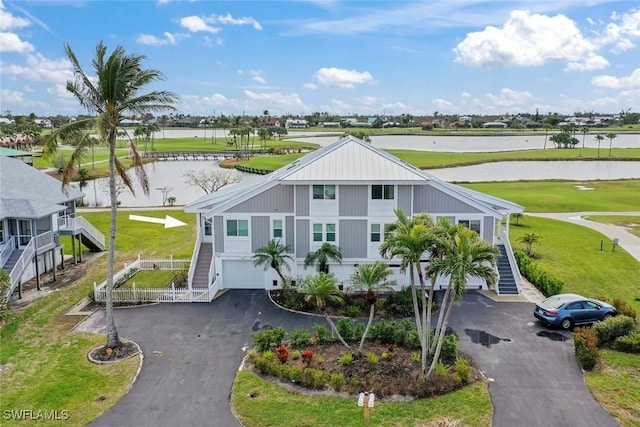 view of front of home featuring a garage and a water view