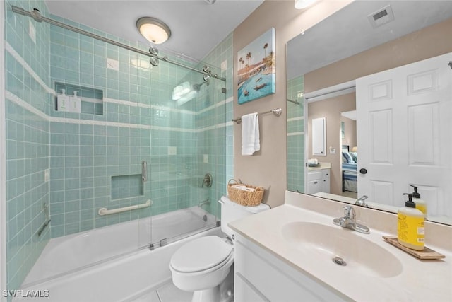 full bathroom with shower / bath combination with glass door, vanity, toilet, and tile patterned flooring