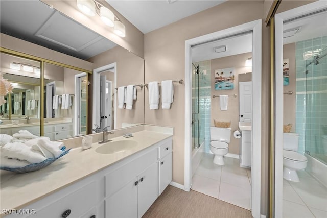 bathroom featuring tile patterned floors, toilet, a shower with door, and vanity