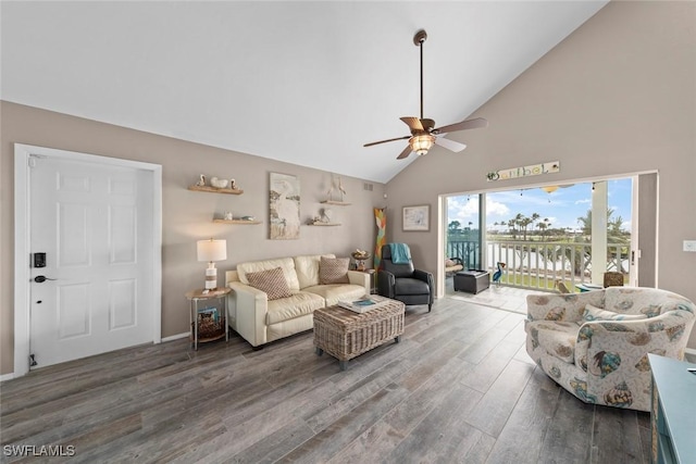 living room with high vaulted ceiling, dark hardwood / wood-style floors, and ceiling fan