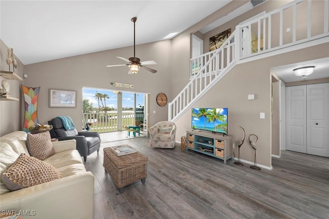 living room featuring dark wood-type flooring, high vaulted ceiling, and ceiling fan