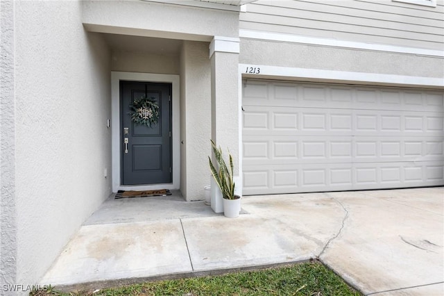 doorway to property with a garage