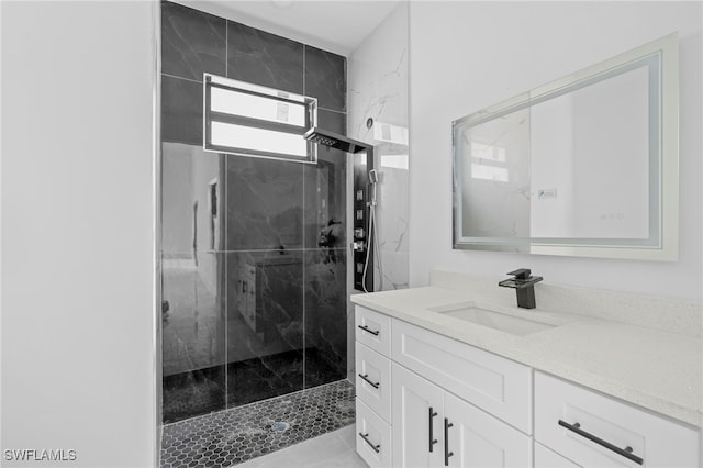 bathroom with vanity and a shower with shower door