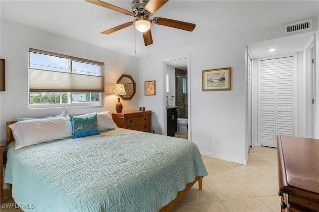 bedroom with light tile patterned floors, ensuite bath, and ceiling fan