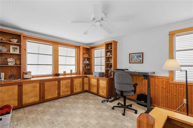 office with ceiling fan and wood walls