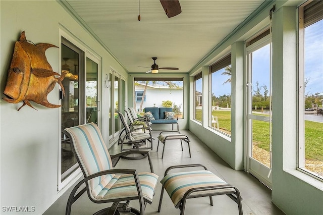 sunroom / solarium featuring ceiling fan and a healthy amount of sunlight