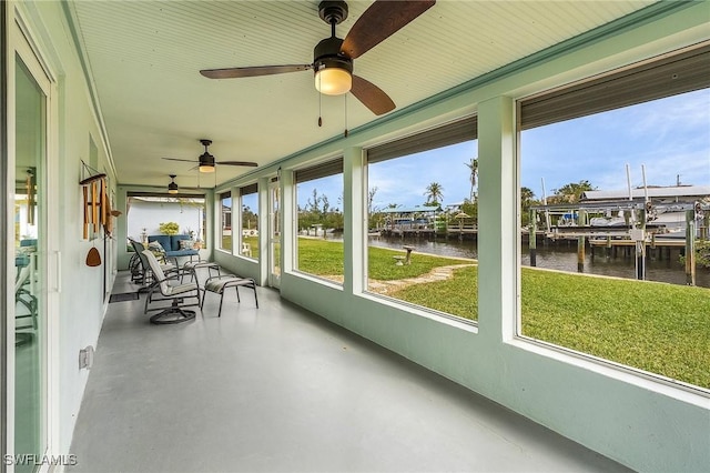 unfurnished sunroom featuring a water view