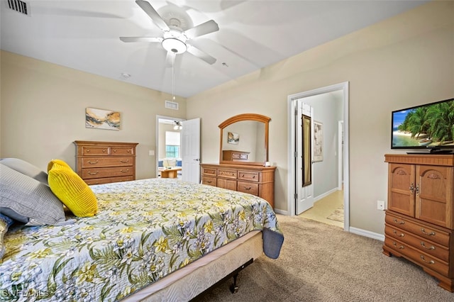 carpeted bedroom featuring ensuite bathroom and ceiling fan