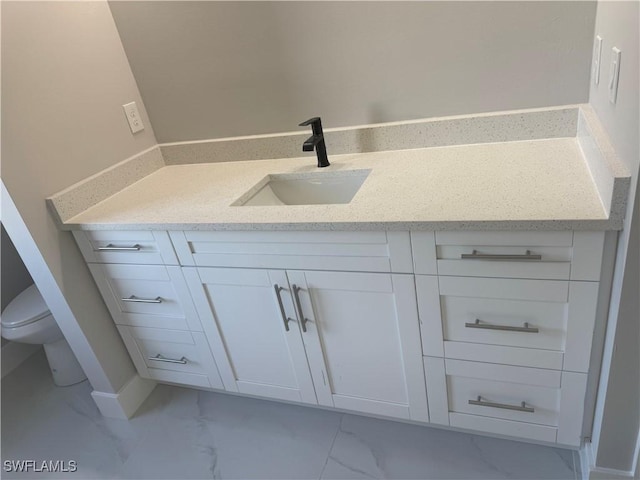 bathroom with vanity and toilet